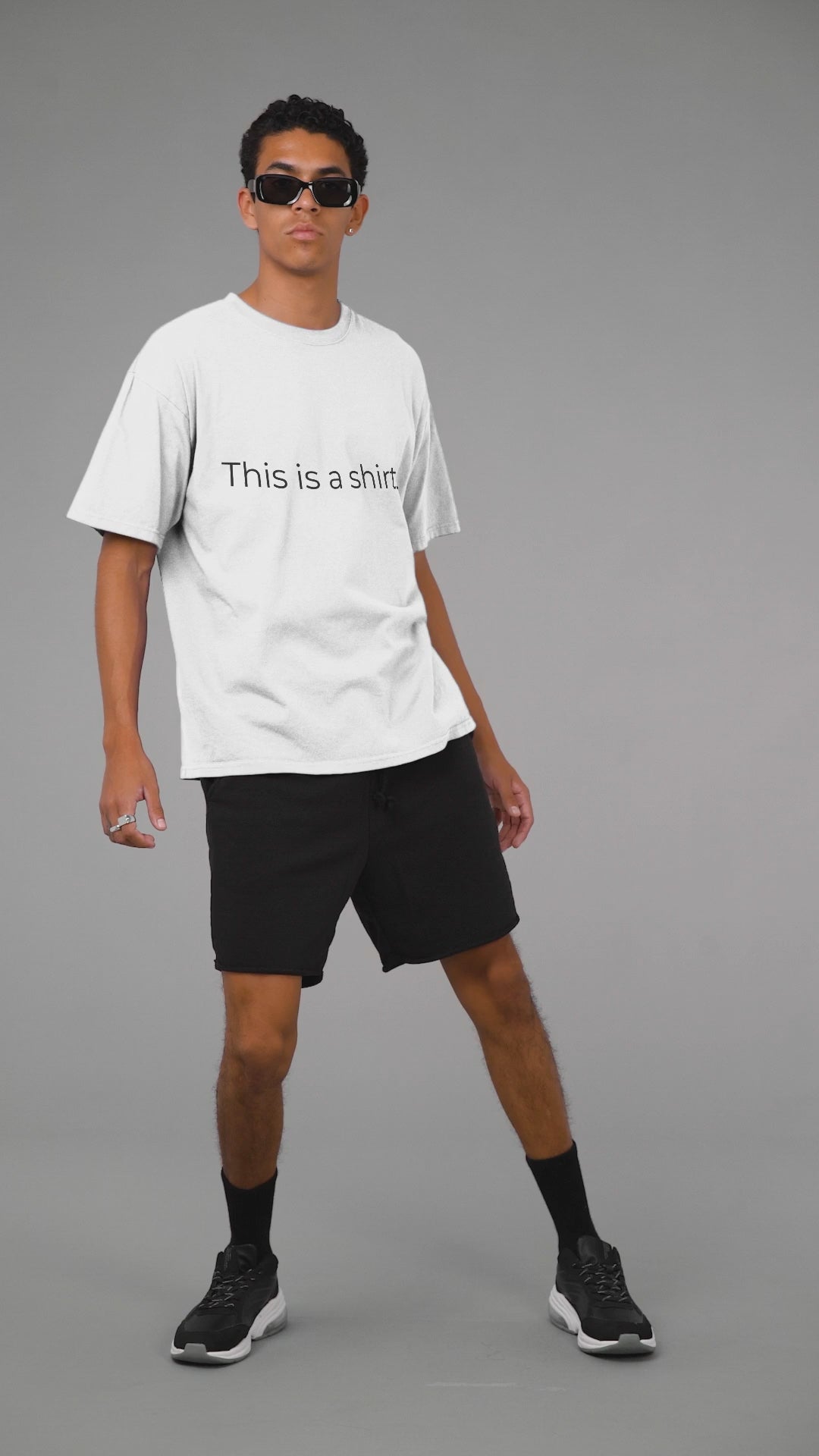 Man showing off a t-shirt with "This is a shirt." written on it.